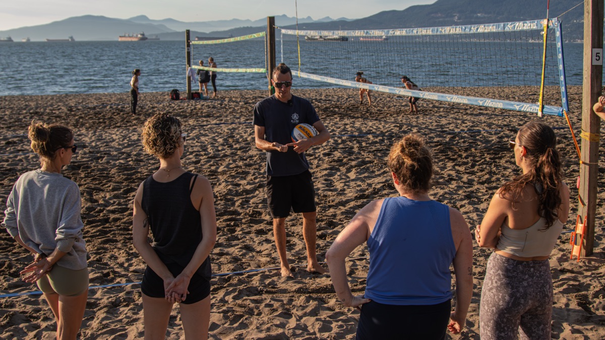 Adam Thompson coaching women at Kits Beach